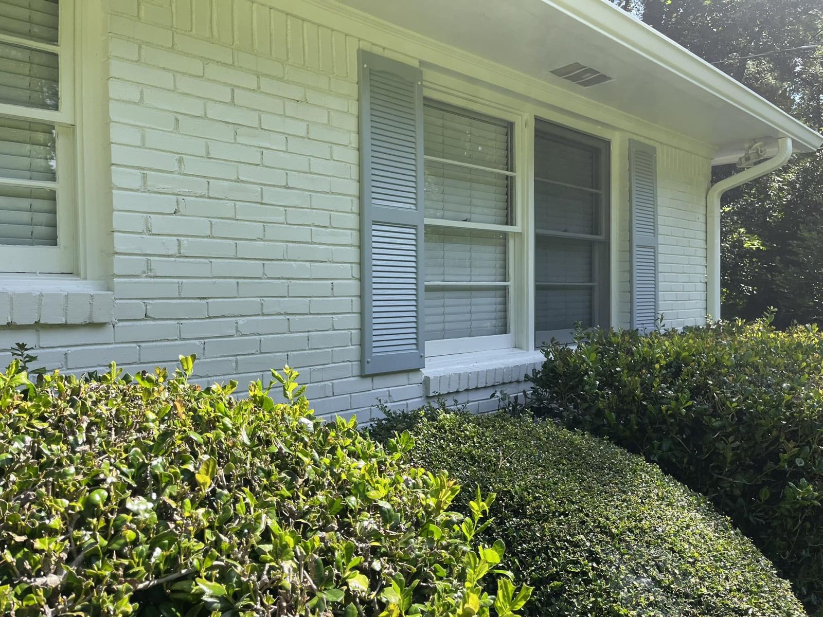 Exterior painting, painted brick house